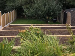 A photograph of decking provided by Blue Iris Landscapes for a steep garden in Stone, Staffordshire